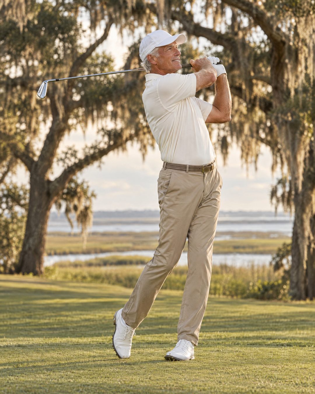 A member finishing his golf swing on a Lowcountry fairway